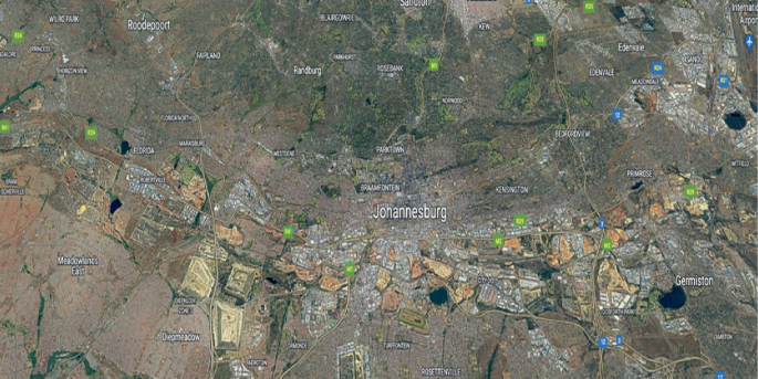 A satellite map of different cities in Johannesburg from a particular height. It consists of grasslands, open fields, and patches of a color used to mark the mines and mining dumps.
