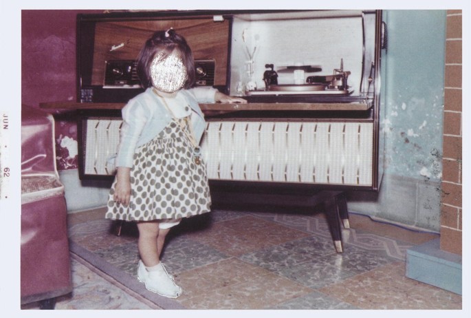 A photograph of a young girl stands near the shelves. The young girl's face is scratched.