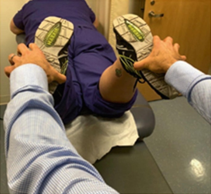 A photograph represents the man holding patients foot for a physical test and a dial test to see the condition of the injury.