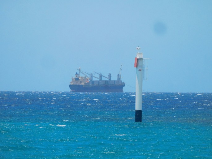 A photo of a container ship on the ocean.