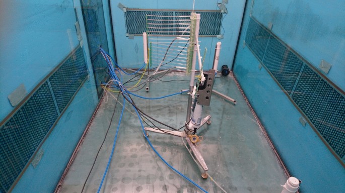 A photo of a chamber with heating pads placed outside the glass. The apparatus with connecting wires is in the center, which connects to the glass surface.