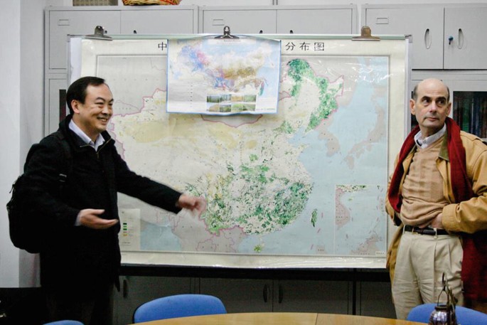 A photograph of Jintao Xu and Peter Berck with a map on a board between them.
