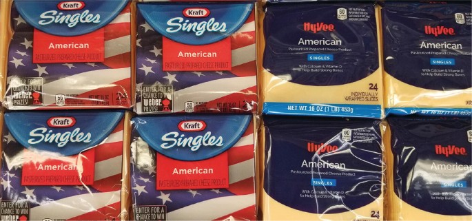 A photograph of 4 packets of singles from Kraft company and 4 packets of singles from Hyvee company.