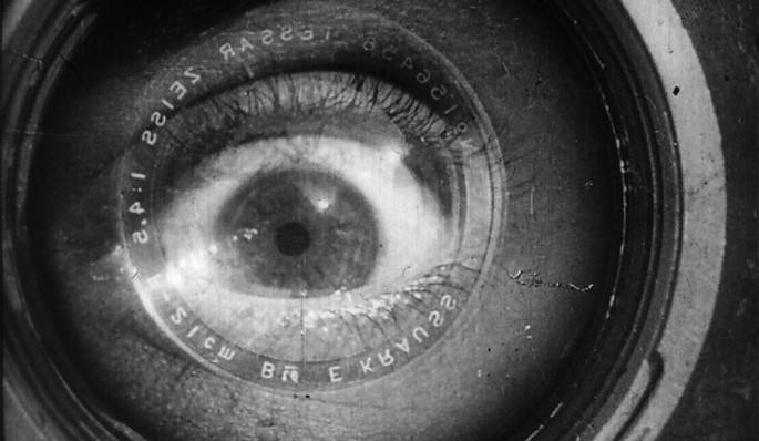 A photo of a wide-opened eye fixed in a camera lens.