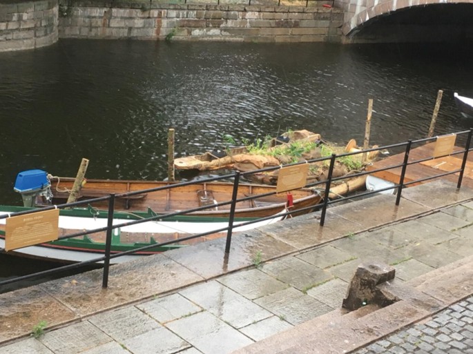 A photograph of floating boat gardens in Akerselva River, Oslo.