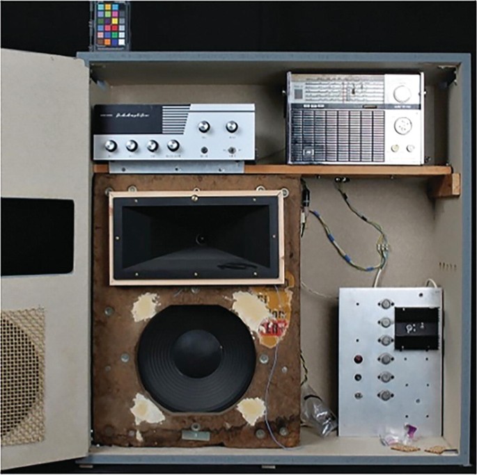 A photograph of the reworked cabinet with new visually different audio devices.