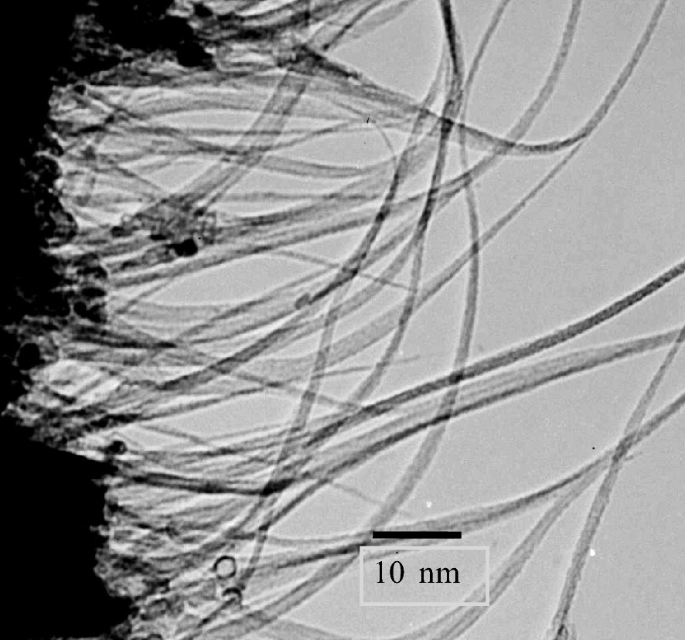 A scanned electron micrograph presents a dark surface on the left side of the plane and thick shaded lines protrude from the patches towards the right direction.