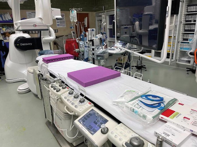 A photo of the hybrid operating room consists of the surgical table, radiology devices, angiography equipment, anesthesia delivery systems, and monitoring and recording systems.
