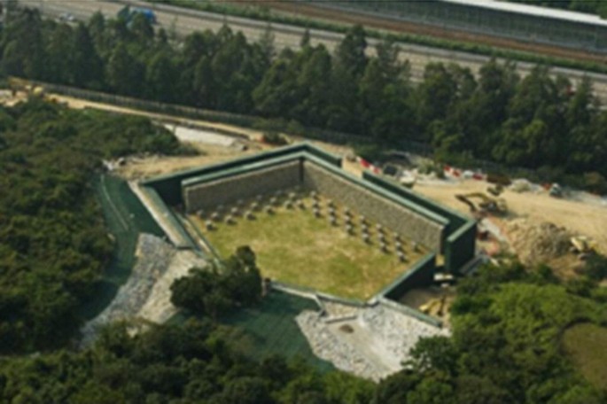 An ariel view photograph of the terminal barrier surrounded by walls and trees.