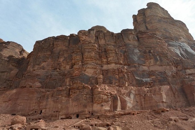 A photograph of the Dadan region with a rock facade.