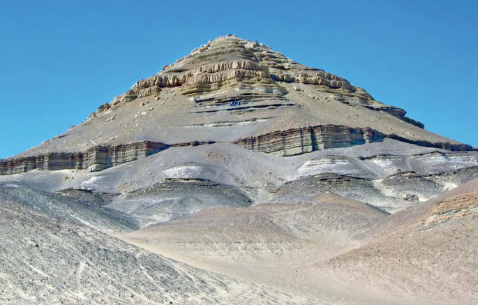 A photograph of the global standard stratotype-section and point of a rock mountain.
