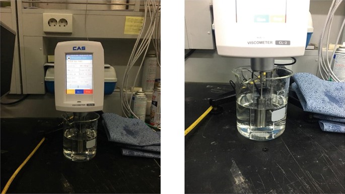 2 photographs. a. Brookfield-type automatic viscometer. b. Focussed on viscous fluid.