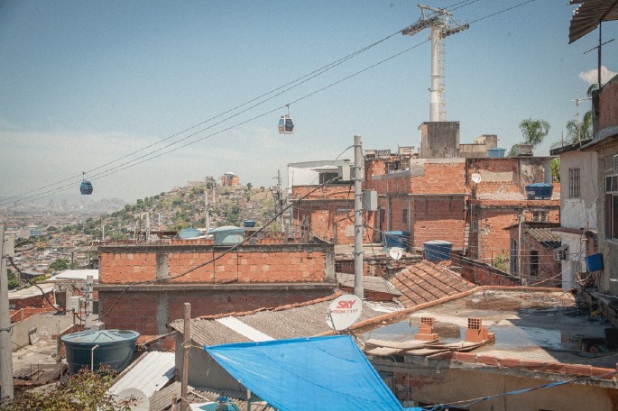 A view of cable cars moving across a crowded locality on a hillside.