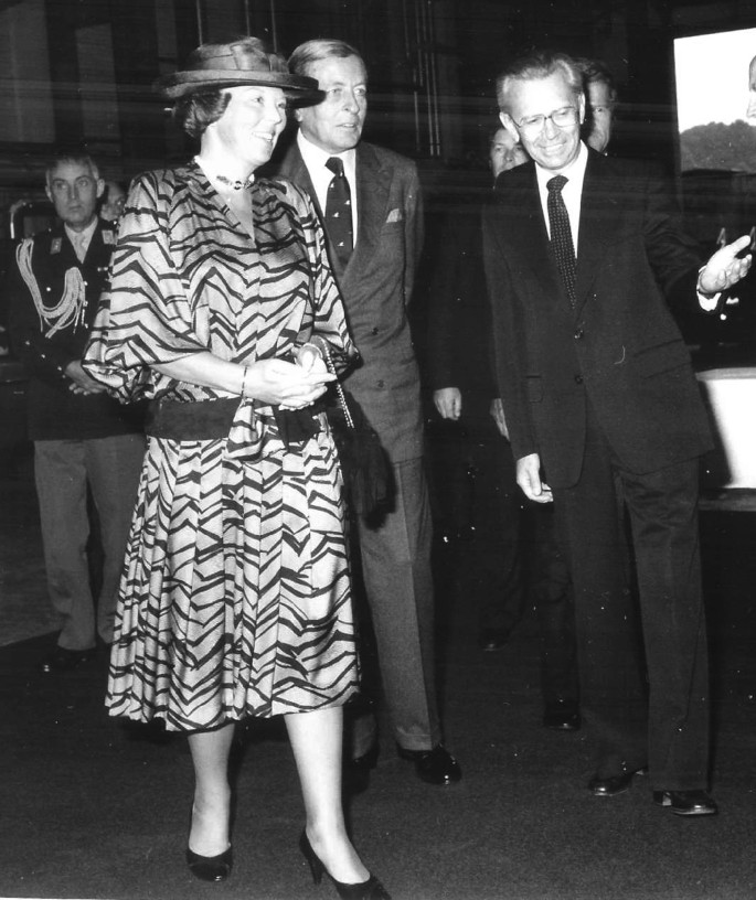 A photograph of Herwig with Queen Beatrix and Prince Klaus. They are having a conversation and smiling.