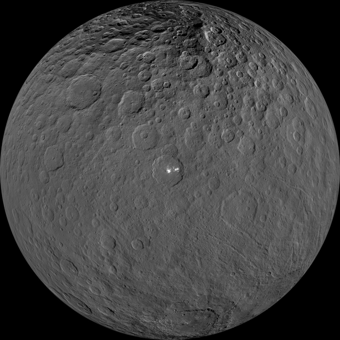 A photograph of the surface of the dwarf planet Ceres. The surface has many circular pits.