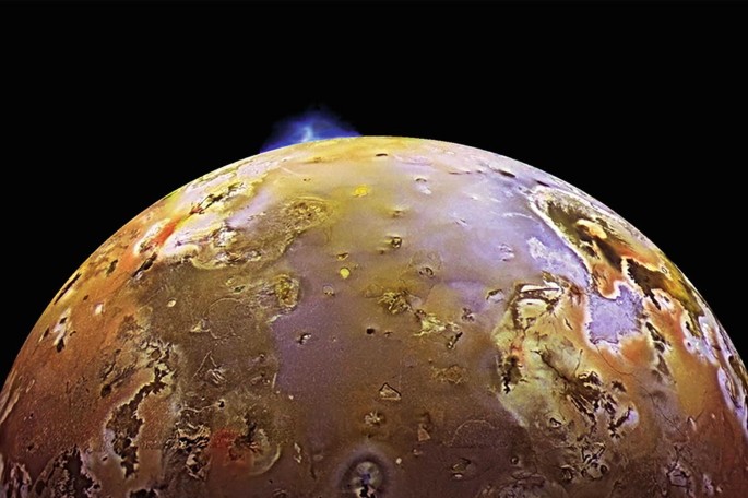 A photograph of a planet displays the phenomenon of volcanic eruption on its surface.