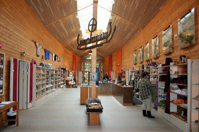 A photograph of an interior of a shop showcasing rock art.