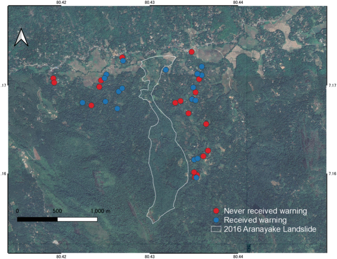 A satellite photograph of an area marks the 2016 Aranayake landslide area as an irregular vertical figure below a road, and more number of dots for respondents who have not received the warning compared to the respondents who have, along the right side of the area and below the road on the left.