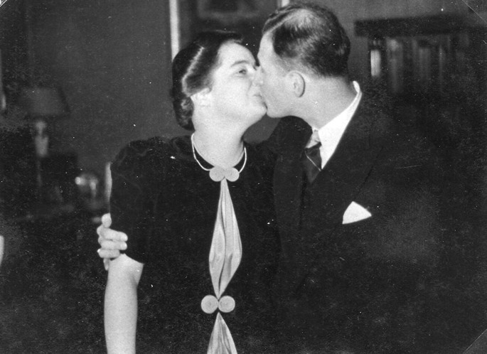 Vintage-style passionate embrace, woman tilting head back as man kisses her deeply, arms wrapped tight