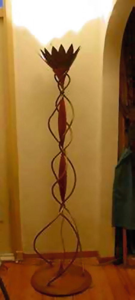 A photograph of a standing lamp that has a spiral structure integrated into the stand.