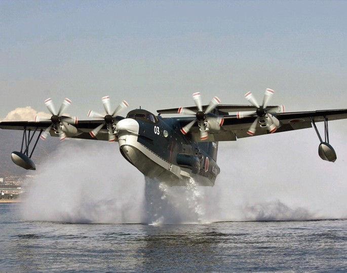 A photo of an aircraft that flies just above a water body.