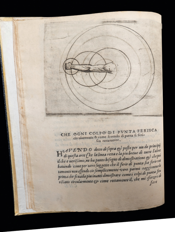 A page of an old book with a sketch on top and a paragraph at the bottom. The sketch has the figure of an arm as big as the radius of the circle. Three more insets of circles are drawn over the arm, enclosing the shoulder, elbow, and wrist, respectively.