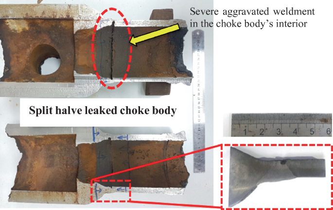 Photograph of the rusted interior part of choke body. The weldment is severely aggravated and the body is split in half.