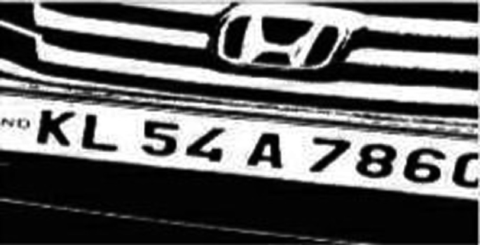 A black and white photograph of the numberplate of a vehicle.