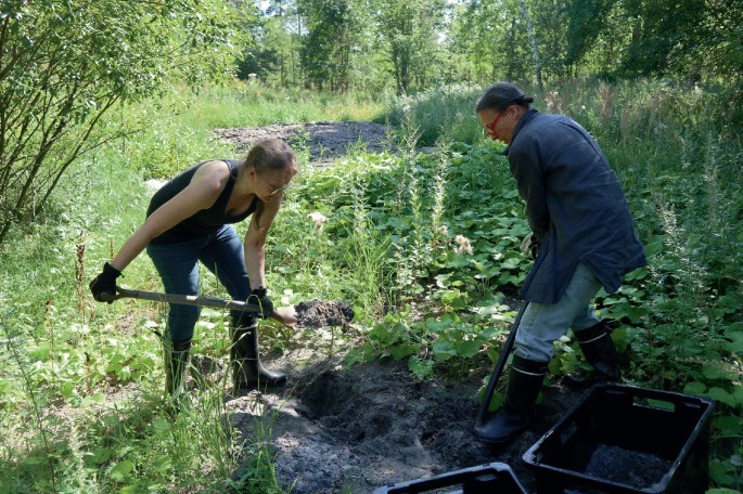 A photograph illustrates two people digging and collecting the soil for the phytoremediation evaluation. It includes green vegetation in the background.