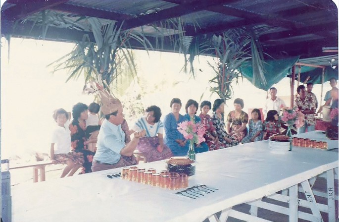 A photo illustrates a child dancing during a celebration of an event. People are sitting on benches.