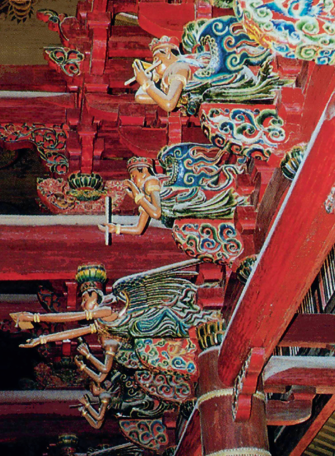A photo of Kaiyuan Temple presents the painted sculptures of angels in the temple doing some activities.