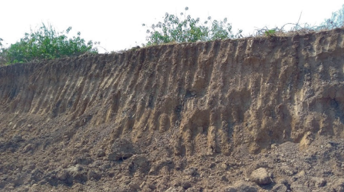 A photograph of a cutting area of highland to form an embankment.