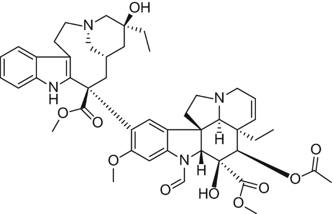 A molecular structure of vincristine with various atoms connected by bonds, including single, double, and dotted lines indicating different types of chemical bonds. The molecule contains multiple rings and functional groups, with atoms labeled.