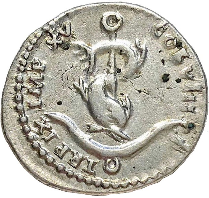 An ancient Roman coin from 80 A D features a dolphin anchor symbol, surrounded by inscriptions.