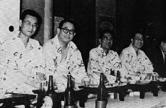 A photograph of KUBS, Kaido, Ichihara, and Urabe, seated in a row.