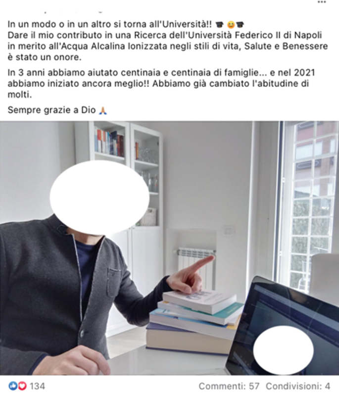 A screenshot of a social media post has a photo of a person seated at a desk, gesturing with one raised forefinger. The face of the person has been redacted.