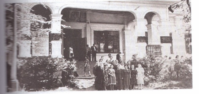 A group photograph of Kazakh women outside an institute.