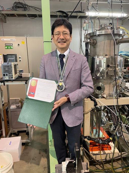 Professor Watanabe is standing beside the multiphase AC arc