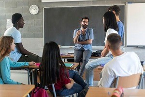 A teacher surrounded by adolescent students during an informal lesson on sexual health 