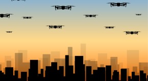 Drones hovering the silhouette of a city
