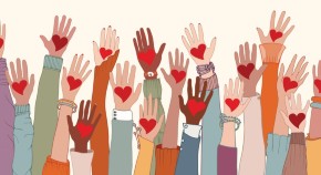 many hands raised in air with hearts on palms