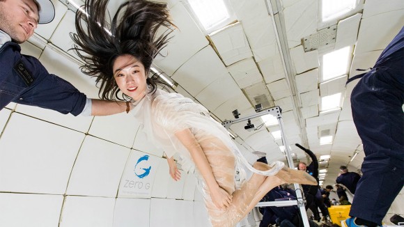 Arts curator Xin Liu testing a costume made from recycled ocean waste, during a parabolic flight.