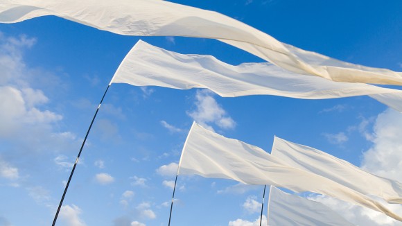 White Flags against blue Sky