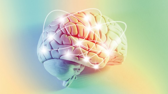 Model of human brain with glowing points of light and light trails, yellow and green gradated background