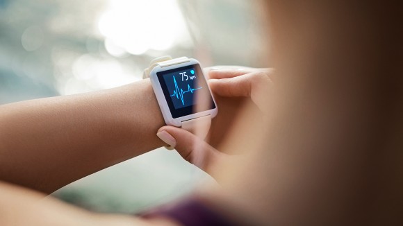 Woman Looking At Her Smart Watch for a pulse trace - stock photo