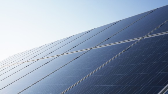 Diagonal solar panels with blue sky behind