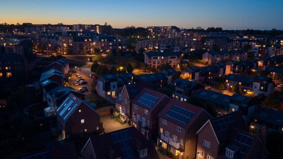 Aerial view of a solar powered housing development at dusk
