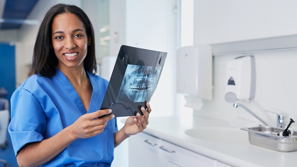 Dentist looking at x-ray of teeth