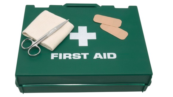 Green first aid box with equipment