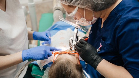 Dentist and dental nurse working on a patient